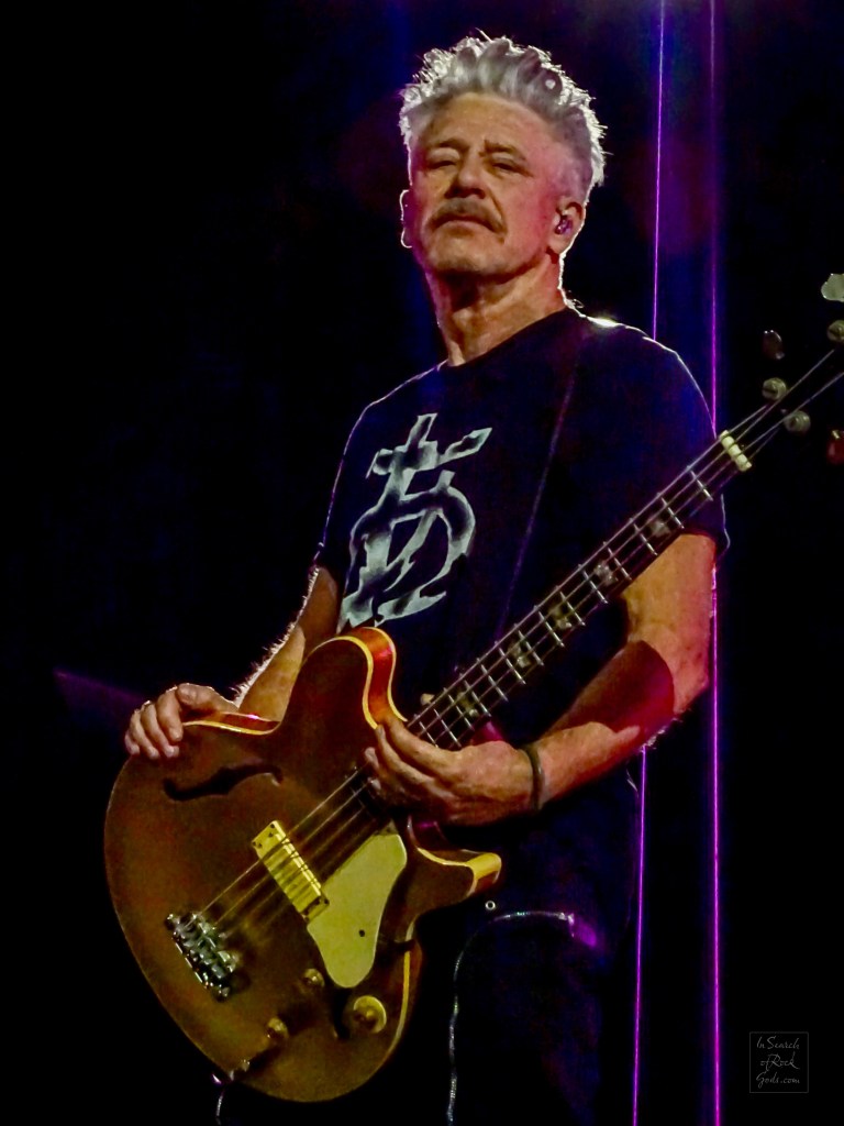 A close up photo of Adam Clayton from U2 playing bass guitar. From the U2:UV Achtung Baby at the Sphere concert in Las Vegas March 1, 2024. 