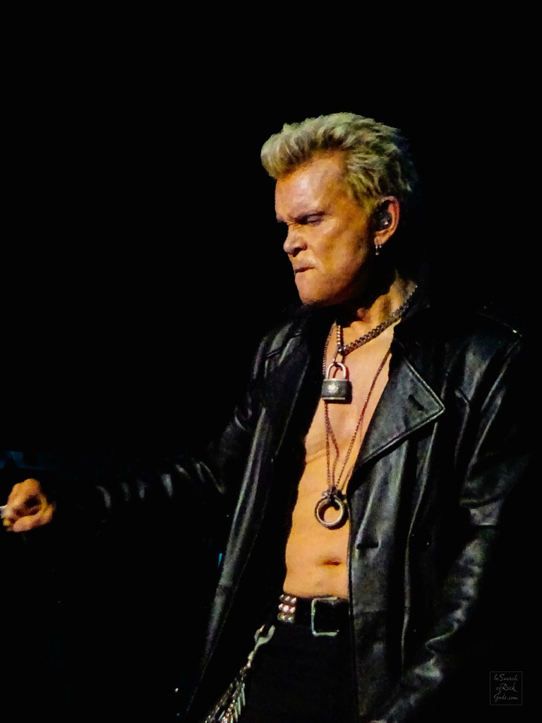 A side portrait photo of Billy Idol in concert at Rogers Place Edmonton Aug 1 2024.