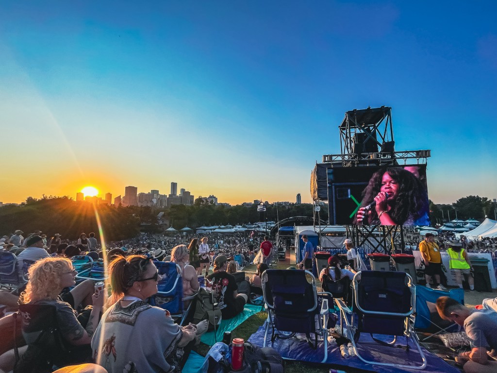 Danielle Ponder on the Jumbotron at Main Stage in the twilight with audience Edmonton Folk Fest 2024