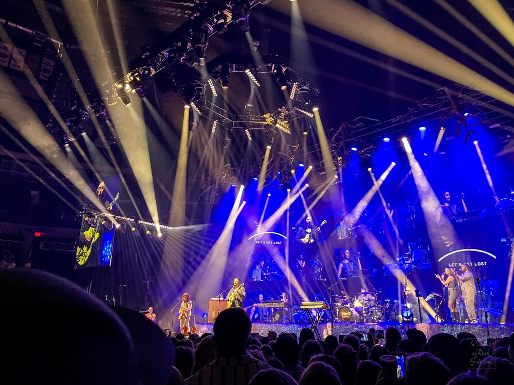 A photo of Hozier in concert with stage lights. Unreal Unearth Tour Rogers Place Edmonton August 24, 2024