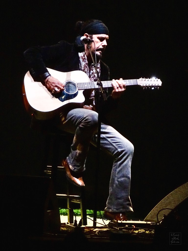 Jeff Martin sitting with Guitar at the Northern Alberta Jubilee Auditorium