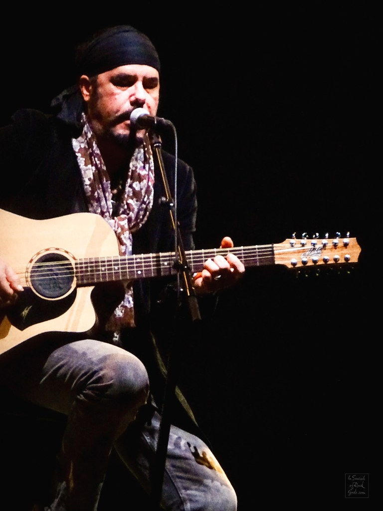 Jeff Martin sitting with Guitar at the Northern Alberta Jubilee Auditorium