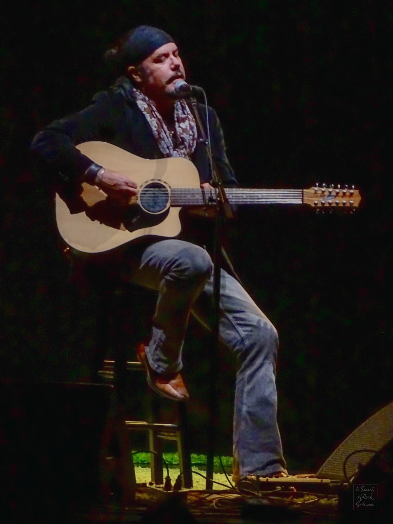 Jeff Martin sitting with Guitar at the Northern Alberta Jubilee Auditorium