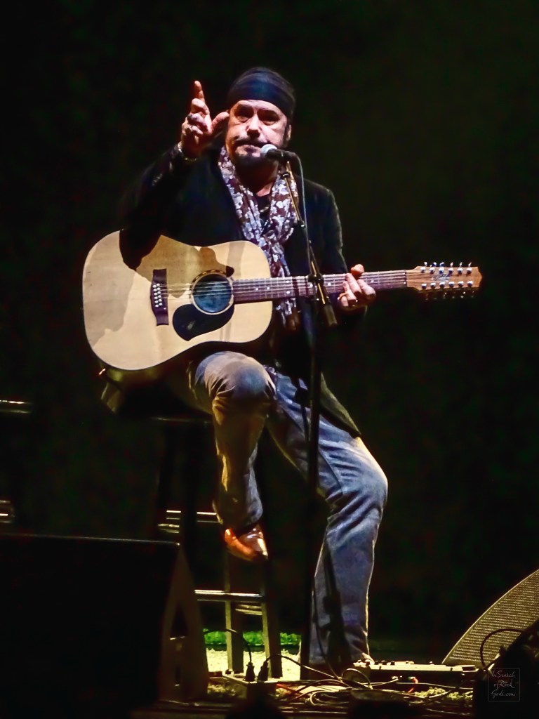Jeff Martin sitting with Guitar at the Northern Alberta Jubilee Auditorium