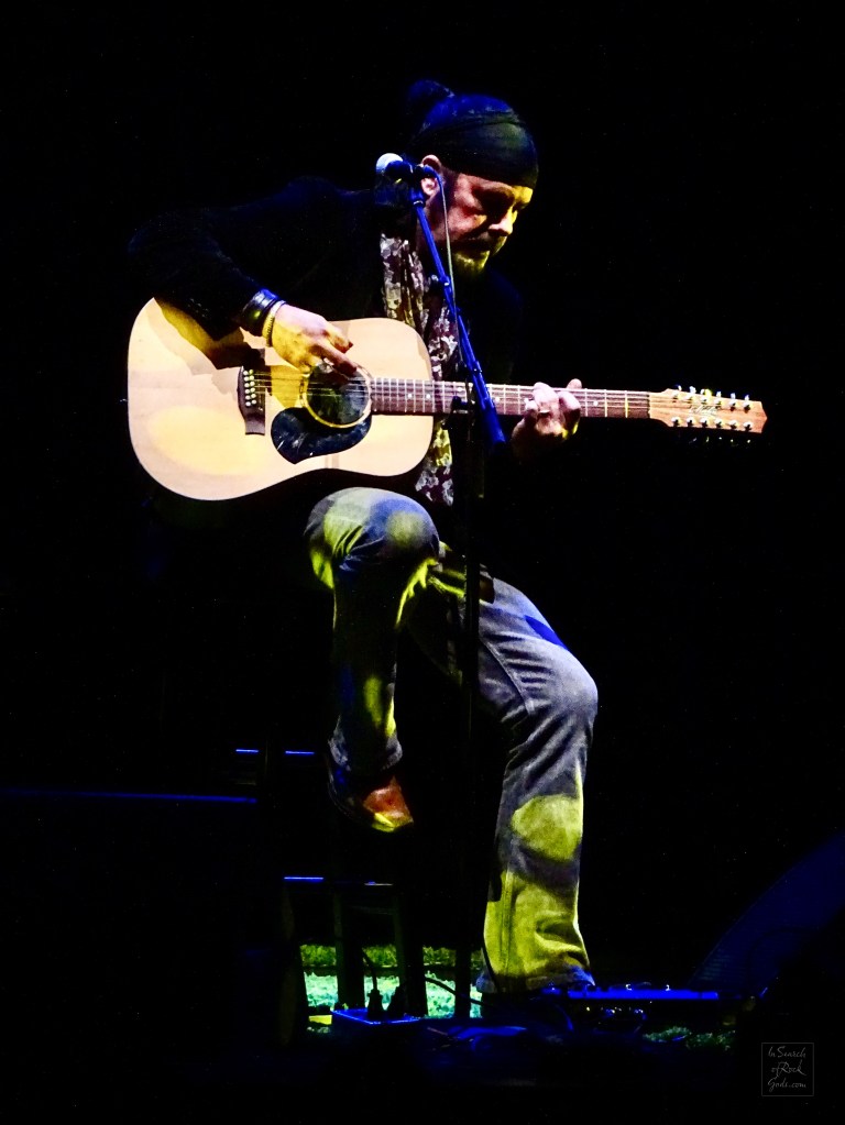 Jeff Martin sitting with Guitar at the Northern Alberta Jubilee Auditorium