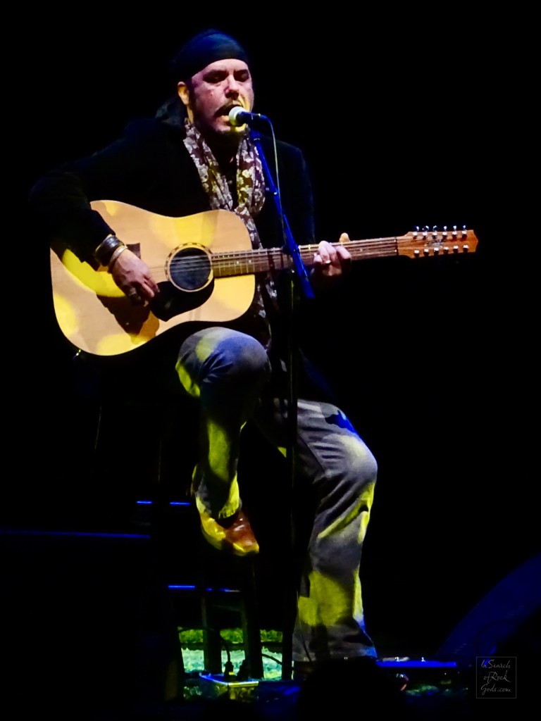 Jeff Martin sitting with Guitar at the Northern Alberta Jubilee Auditorium