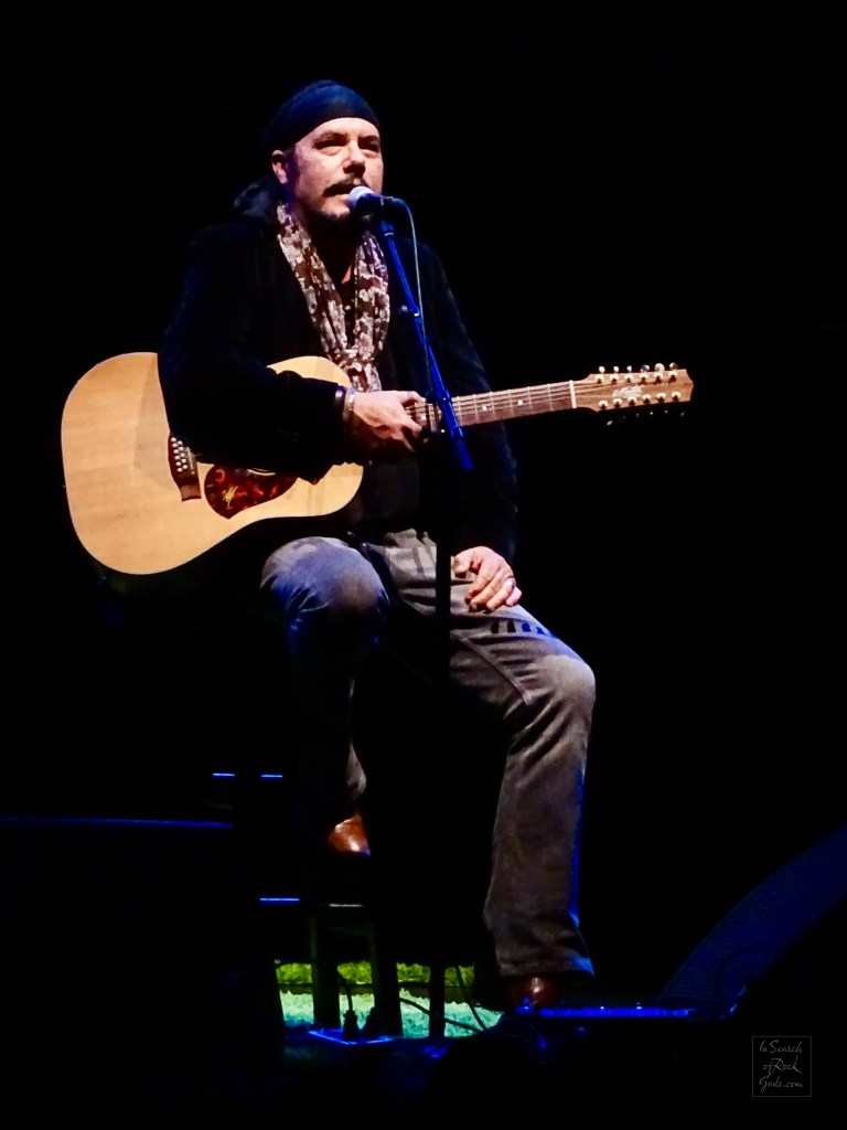 Jeff Martin sitting with Guitar at the Northern Alberta Jubilee Auditorium