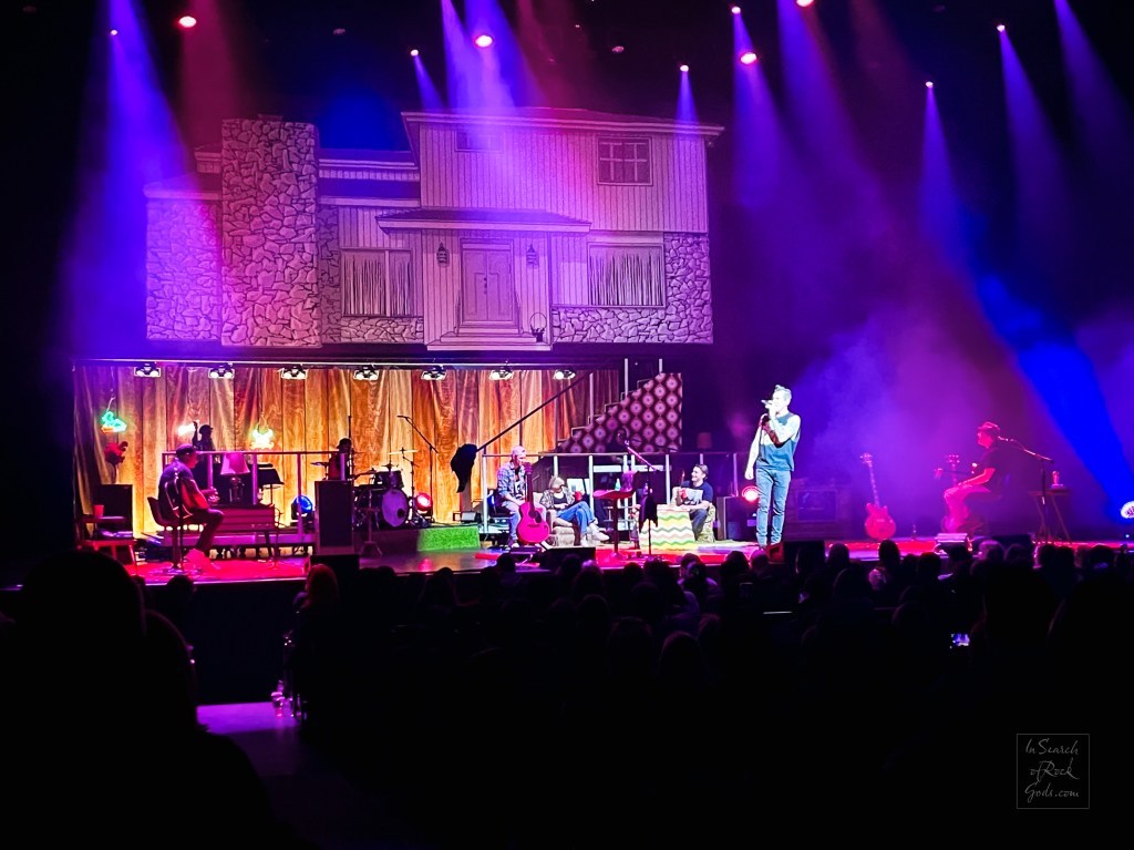 Theory of a Deadman at Northern Alberta Jubilee Auditorium stage with a house exterior on the screen